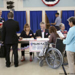 Workers working at registration table in polling place