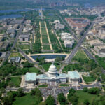 Aerial view from above the United States Capitol Building, looking west along the National Mall.