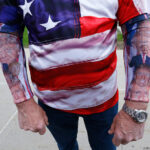 Chris Wolfersberger, of Ephrata, Pa., shows off his arm bands with the likeness of Republican presidential candidate Donald Trump as he waits in line to enter the Pennsylvania Farm Show Complex and Expo Center ahead of a rally for Trump, Thursday, April 21, 2016, in Harrisburg, Pa.