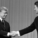 1980 file photo, President Jimmy Carter shakes hands with Republican Presidential candidate Ronald Reagan.
