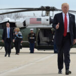 President Donald Trump gives a thumb-up as he walks from Marine to Air Force One at General Mitchell International Airport in Milwaukee