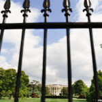 The White House in Washington, D.C. behind a iron fence. Credit: ©BananaStock/PunchStock