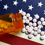 Prescription pills spilled on USA flag