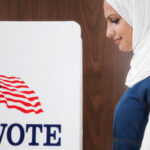 Middle Eastern voter voting in polling place