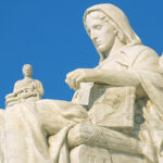 Low angle, side view of Contemplation of Justice by James Earle Fraser on the left of the steps of the United States Supreme Court Building, Washington D.C., USA