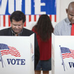 Voters voting in polling place;