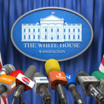 White House press conference podium with microphones.