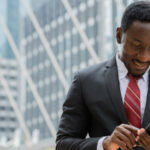Young African businessman using mobile phone