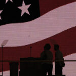 American flag on a large digital monitor as a stage background at a Republican Party convention.