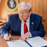 President Donald Trump signs an Executive Order