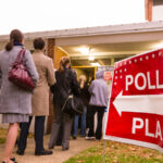 Voters line up outside of a Election Day polling location.