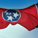 Tennessee state flag unfurled by a stiff breeze.